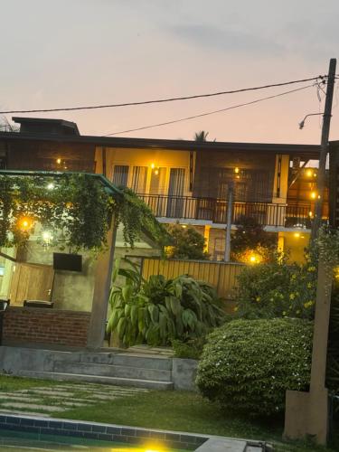 a house at night with lights in the yard at SaDev Lake Villa Bandaragama in Bandaragama
