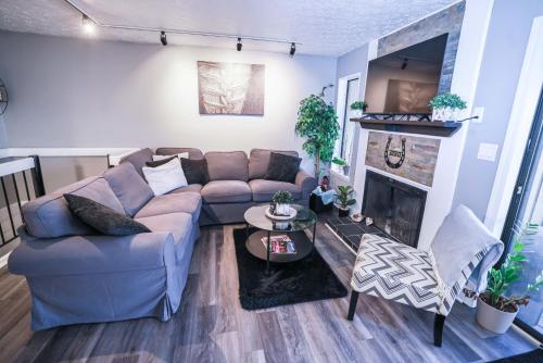 a living room with a couch and a fireplace at Cozy Retreat Golf, Lake & Nature at Beautiful Lake Monroe in Bloomington