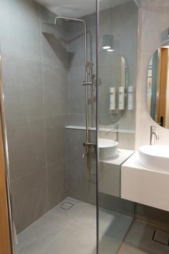a bathroom with a shower and a sink at Southernheal Hotel in Haenam