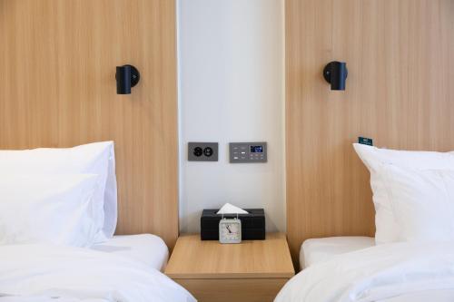 Postel nebo postele na pokoji v ubytování Southernheal Hotel