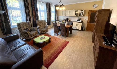 a living room with a couch and a table at Ostseebad 22 in Prerow
