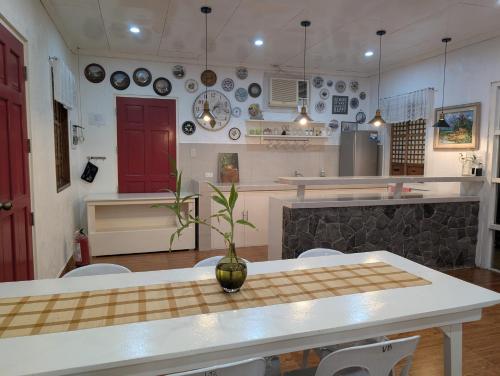 a kitchen with a table with a vase on it at VistaBerge Pavilion Suite in Bangwang