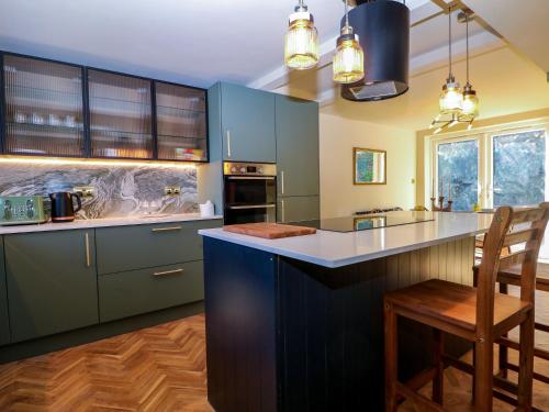 a kitchen with blue cabinets and a counter top at Hyrst Rise in Forest Row