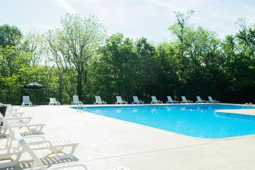 a swimming pool with chairs and a bunch ofitures at Cozy Retreat Golf, Lake & Nature at Beautiful Lake Monroe in Bloomington