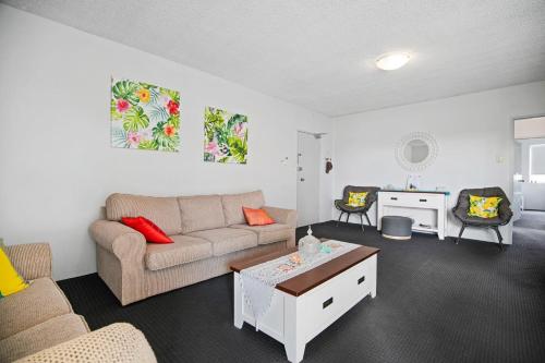 a living room with a couch and a table at Cul-de-Sac Cove, Unit 4 in The Entrance