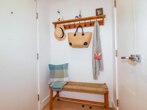 a hallway with a bench and a towel rack at 4 Ocean Gate in Newquay