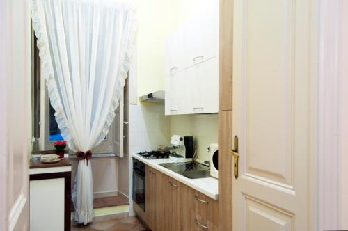 a kitchen with a sink and a stove top oven at B&B Villa Roma in Piazza Armerina