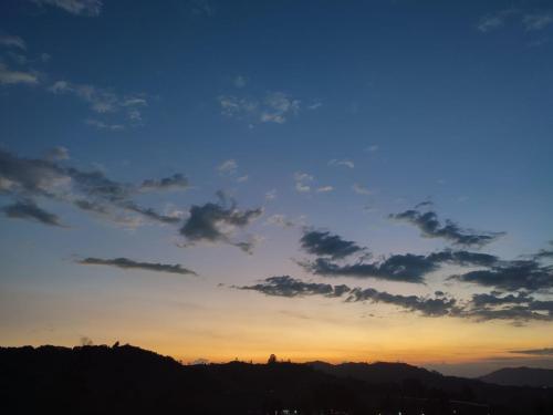 a sunset with a blue sky and some clouds at San Gabriel Via Termales Santa Rosa in Santa Rosa de Cabal