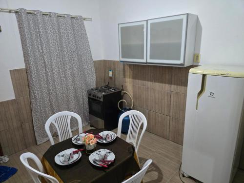 a small kitchen with a table and a refrigerator at Apto J com cozinha em Macapá in Macapá