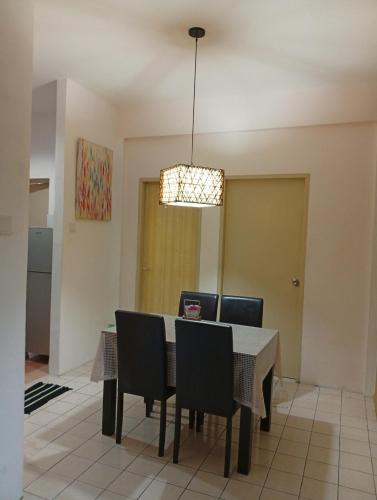 a dining room with a table and chairs at Teratak RIZQ Kota Samarahan in Kota Samarahan