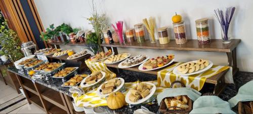 a buffet with many plates of food on a table at Ziyorat Luxury Hotel in Fergana