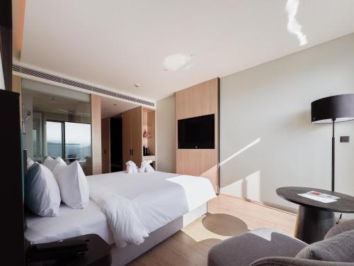 a hotel room with a bed and a tv at December Hotel in Nha Trang