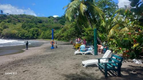 a group of people sitting on a beach at Michael's Beach Complex #3 in Brighton Village