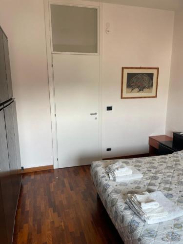 a bedroom with a bed and a sliding door at DOLOMITI 5.3 in Verona