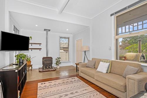 a living room with a couch and a flat screen tv at Albany Beachside Accommodation in Albany