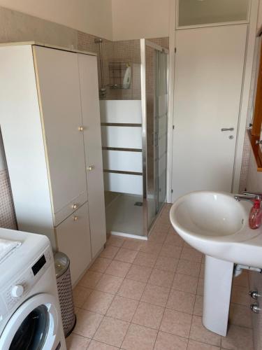 a bathroom with a sink and a washing machine at DOLOMITI 5.3 in Verona