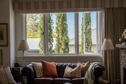 a living room with a couch and a large window at Blackheath Getaway in Blackheath