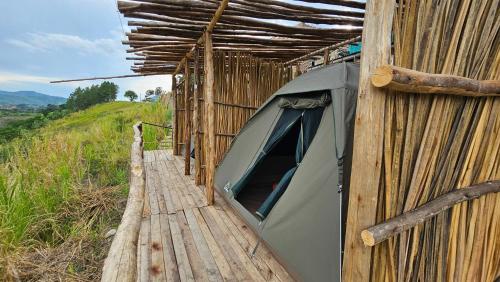 a tent on the side of a building at Twin Lakes Eco Lodge Campsite in Rubirizi