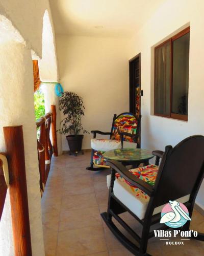 a living room with chairs and a table at Hotel Villas Ponto Holbox in Holbox Island