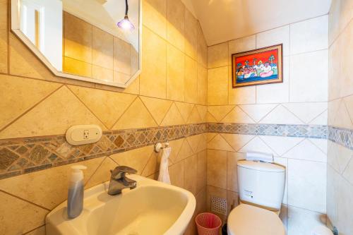 a bathroom with a toilet and a sink at Paraiso Presidential 20 -Ocean View Penthouse And Digital Nomad Haven in Playa Flamingo