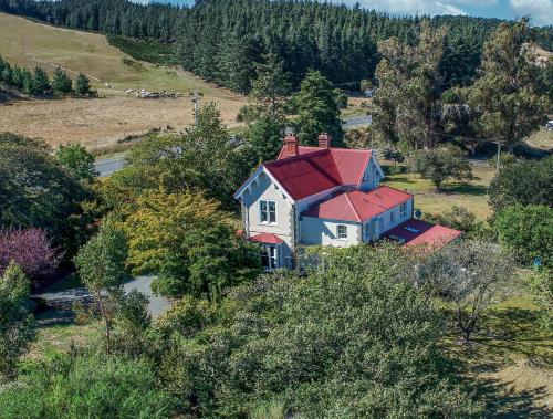 a house with a red roof on top of a hill at Ardross House in Amberley