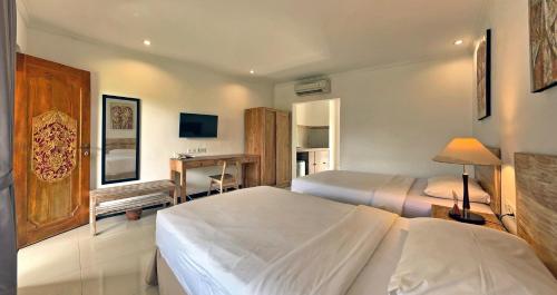Ένα ή περισσότερα κρεβάτια σε δωμάτιο στο Sanur Lodge