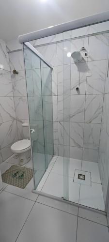 a bathroom with a glass shower with a toilet at AP Central VIP 02 in Campina Grande