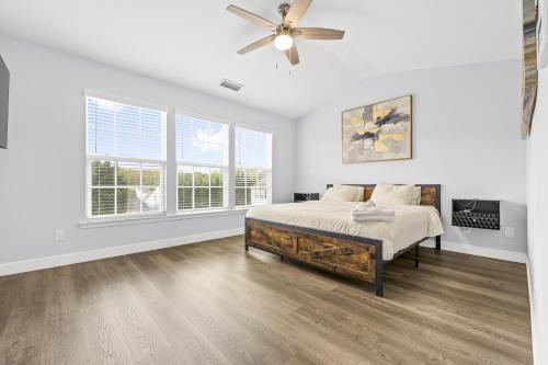 a bedroom with a bed and a ceiling fan at 3BR Family Retreat with Modern Comforts in Charlotte