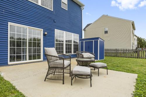 a patio with two chairs and two chairs and a house at 3BR Family Retreat with Modern Comforts in Charlotte