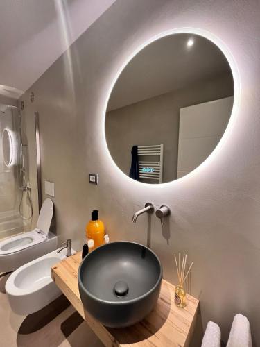a bathroom with a black sink and a mirror at The Barn among olive trees in Ponte a Ema