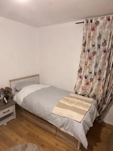 a bedroom with a bed with a curtain on it at Baierrefreies Apartment Stielzchen Steinbeck in Recke