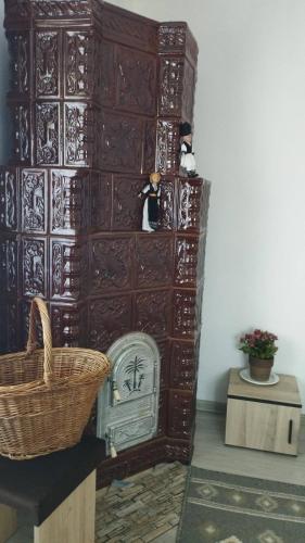 a large wooden cabinet in a room with a basket at PRIDVOR de STOENESTI in Bîrlogu