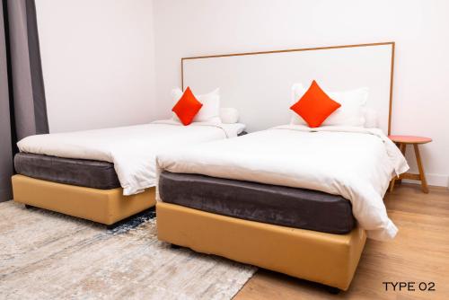 two beds sitting next to each other in a bedroom at MU Hotel in Ipoh