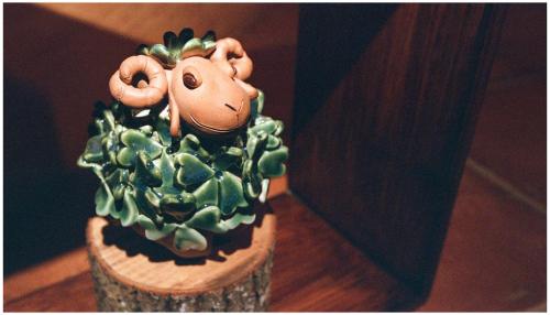 a toy monkey sitting on top of a plant at Errantry Lodge & Studio in Hualien City