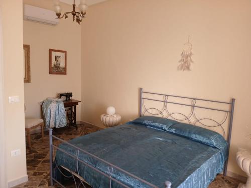 a bedroom with a bed with a blue comforter at Palazzo delle favole in Ostuni