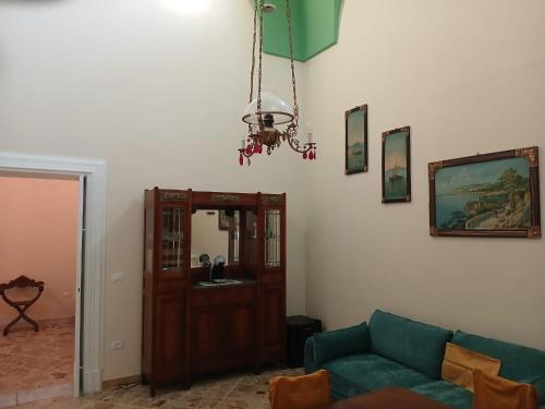 a living room with a couch and a chandelier at Palazzo delle favole in Ostuni