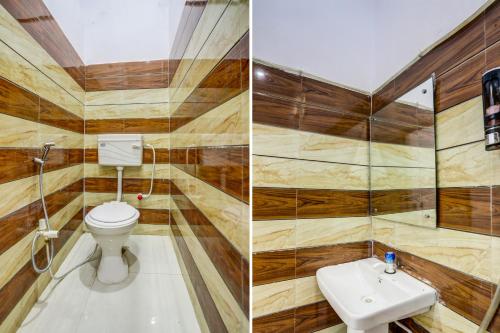 a bathroom with wooden walls and a toilet and a sink at Hotel O KAVYA RESIDENCY in Alīgarh