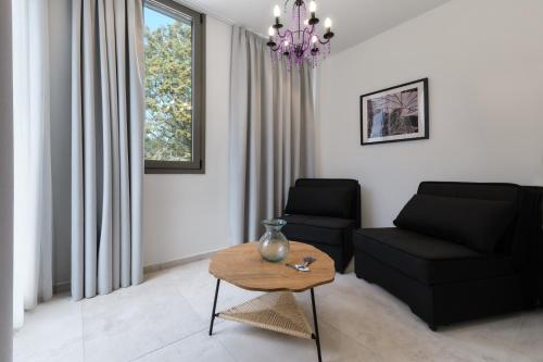 a living room with a couch and a table at Mythical Coast Wellness Retreat in Mytilini