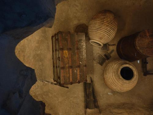 a rusty object on a wall with a coil at Rubeas Towers - Pyrgos Towers Complex in Pírgos