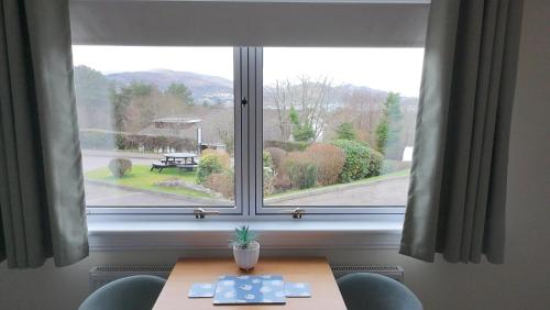 a table in front of a large window at Innisfree Guest House in Fort William