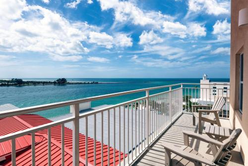 a balcony with chairs and a view of the ocean at Hampton Inn and Suites Clearwater Beach in Clearwater Beach