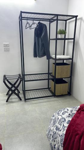 a black rack with a jacket on a shelf at Al-Yarmouk sanctuary in Balad ash Shaykh