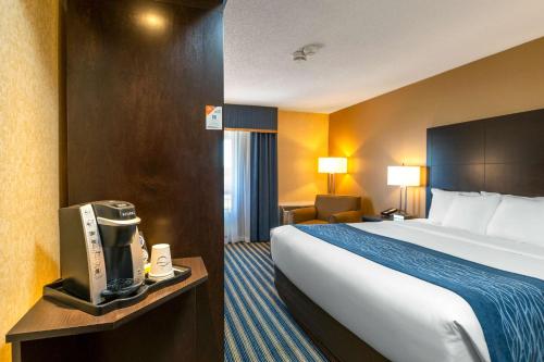 a hotel room with a bed and a television at Comfort Inn in Saint Thomas