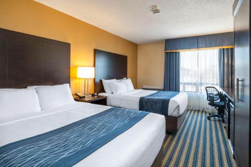 a hotel room with two beds and a window at Comfort Inn in Saint Thomas