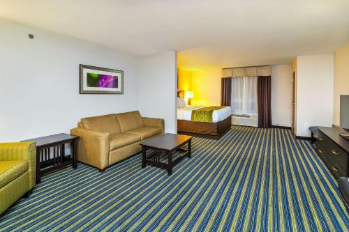 a hotel room with a couch and a bed at Comfort Inn & Suites in Moose Jaw