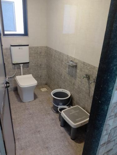 a bathroom with a toilet and a sink at Wantara resort in Diveagar