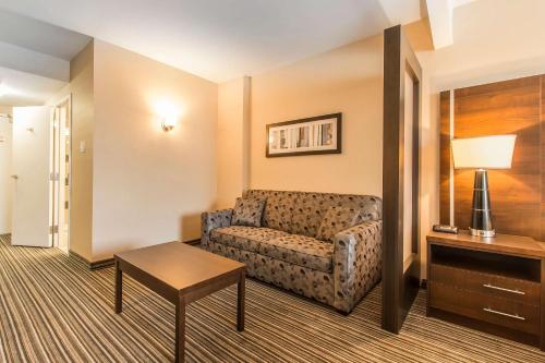 a living room with a couch and a table at Comfort Suites Downtown in Montreal