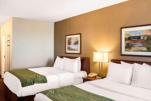 a hotel room with two beds and a phone at Comfort Inn in Halifax