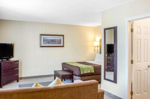 a hotel room with a bed and a couch at Comfort Inn in Halifax