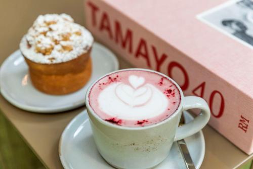 a cup of coffee and a cupcake on a table at Andaz Condesa Mexico City, By Hyatt in Mexico City